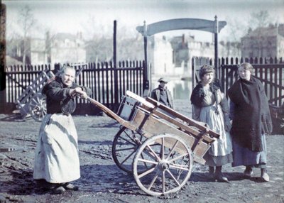 Old Woman with a Cart on a Muddy Road, with Two Girls and a Boy, France, c.1914-18 by French Photographer